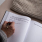 Someone writing in the 'in other words' book created by EMF publishing 
