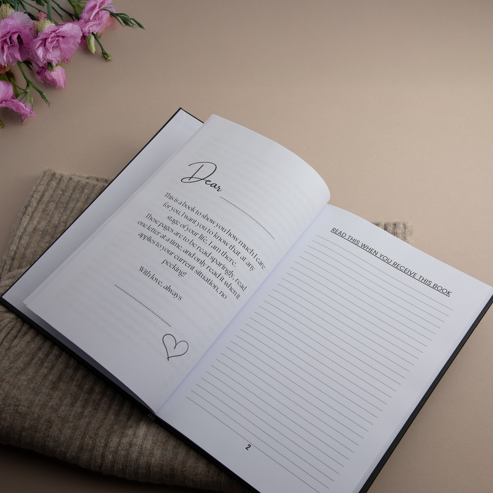 The first page of the book in other words next to some pink flowers and a beige background