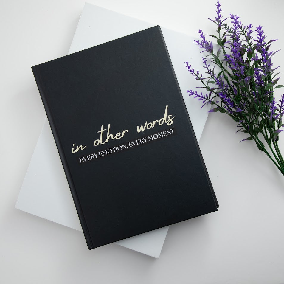 In other words book next to some purple flowers. Created by EMF publishing