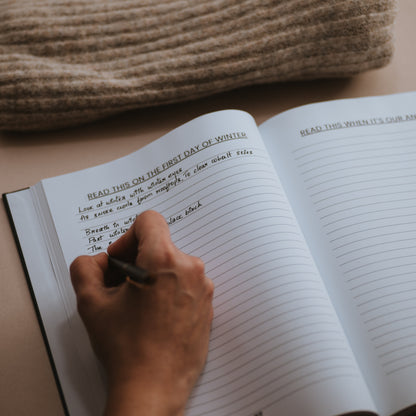 Inside the book 'in other words' as someone writes out their answer with a beige background 